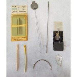 Lot of vintage sewing needles and assorted sewing items.